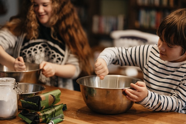 Two children cooking together in a kitchen